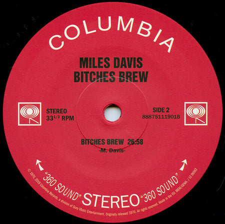 Miles Davis Bitches Brew vinyl record label, red Columbia label, classic jazz album.