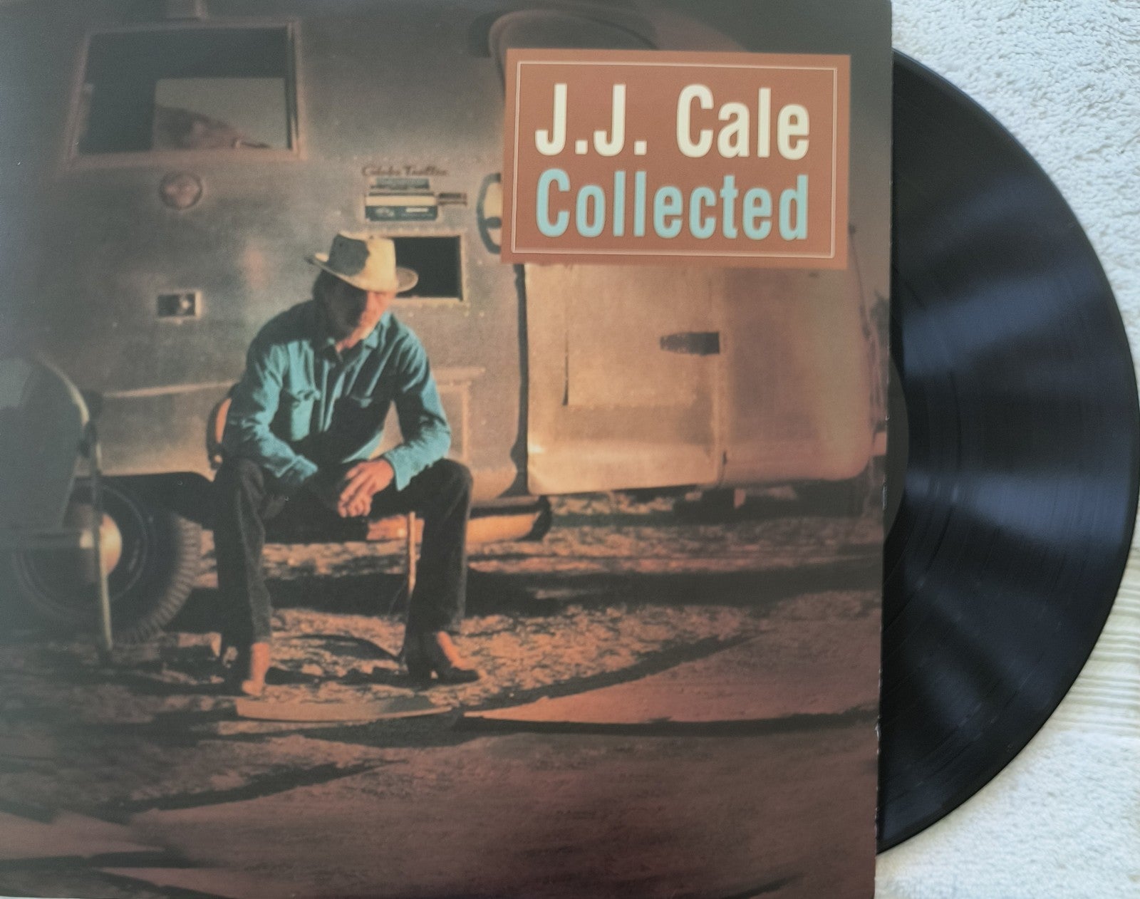 J.J. Cale Collected vinyl record album cover with man in cowboy hat sitting outside trailer.