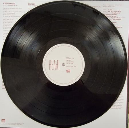 Heart vinyl record on white background with visible tracklist and EMI label