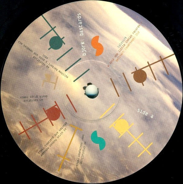Colorful abstract design on Björk Bastards vinyl record label with tracklist and sky background.