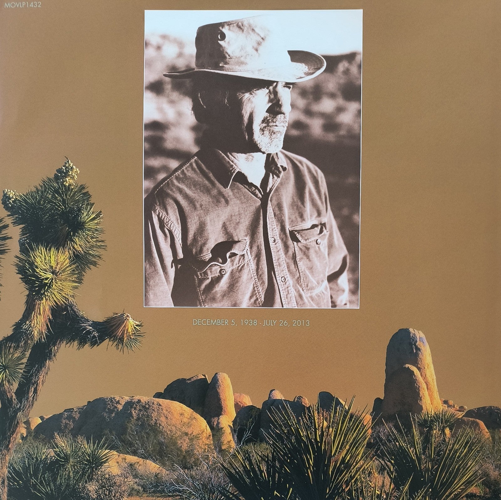 Sepia-toned desert landscape with Joshua trees and rocks, inset black-and-white portrait of an older man in a hat.