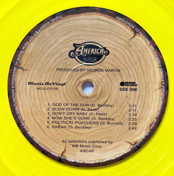 Yellow vinyl record, America Harbor album side one label, tracklist and credits visible.