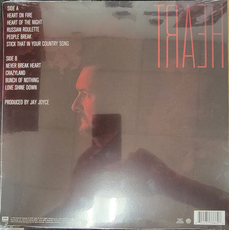 Vinyl record album back cover with man in profile, tracklist, and bold red 'HEART' title.