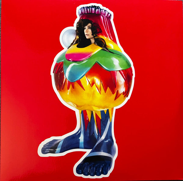 Surreal vinyl album cover with a colorful, costume-clad figure on a vivid red background.