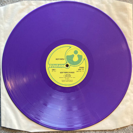 Purple vinyl record of Deep Purple In Rock with yellow Harvest label on white sleeve