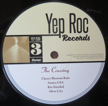 Yep Roc Records vinyl label for The Crossing album, tracklist visible on record.