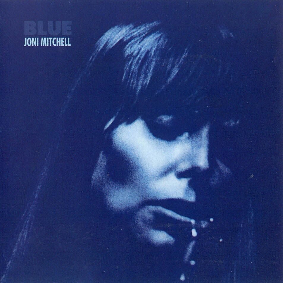 Joni Mitchell Blue album cover with moody blue-toned portrait, classic vinyl record art