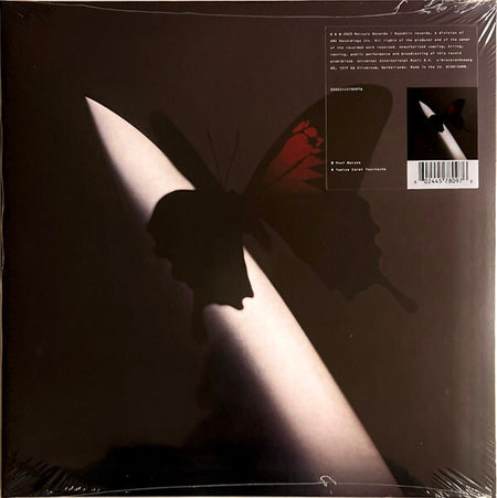Vinyl record album cover featuring a dark butterfly shadow cast on a sharp white object, minimalist design