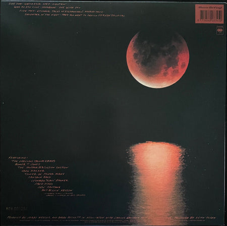 Vinyl record cover featuring a red lunar eclipse over dark water with moon reflection.