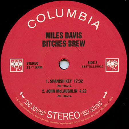 Miles Davis Bitches Brew vinyl record label, red Columbia label featuring track titles and durations.