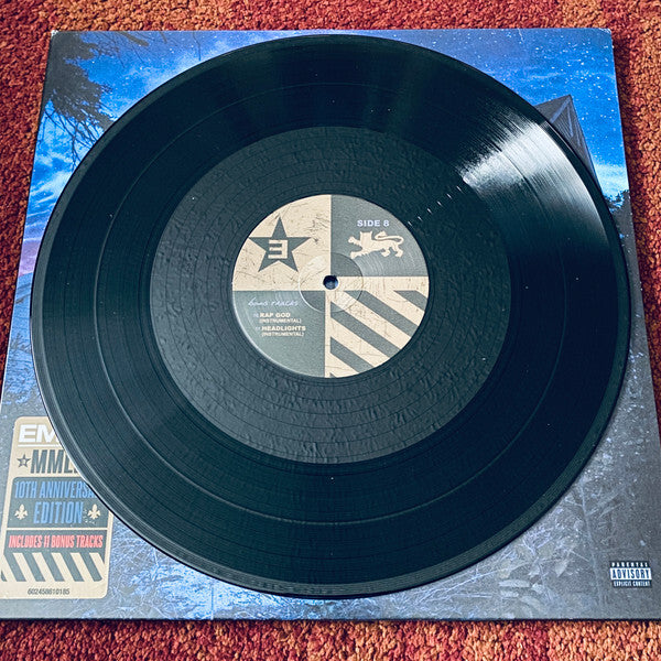 Black vinyl record on album cover, 10th anniversary edition with bonus tracks sticker