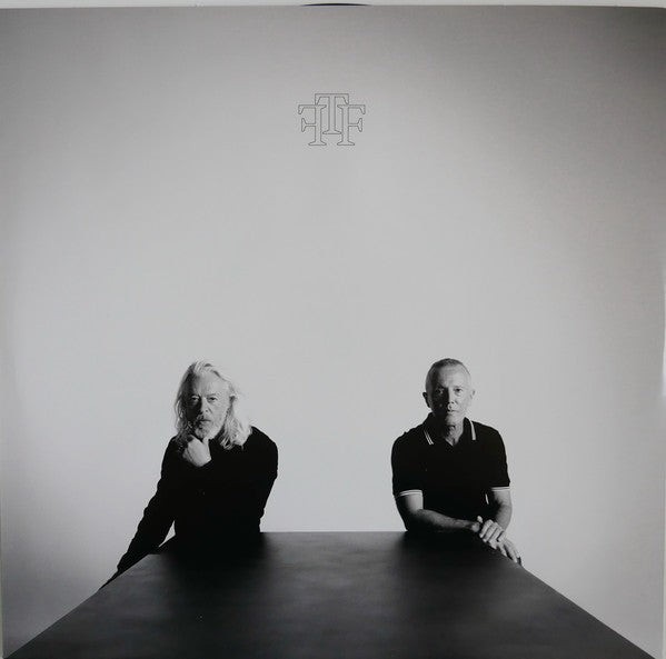 Black and white vinyl album cover with two men sitting at a table, minimalist design, music record